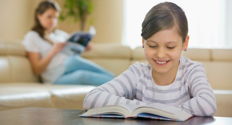 Girl and parent enjoying summer reading time
