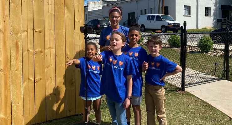 Children and adult wearing matching blue T-shirts at family activity event in Greenville, SC area.