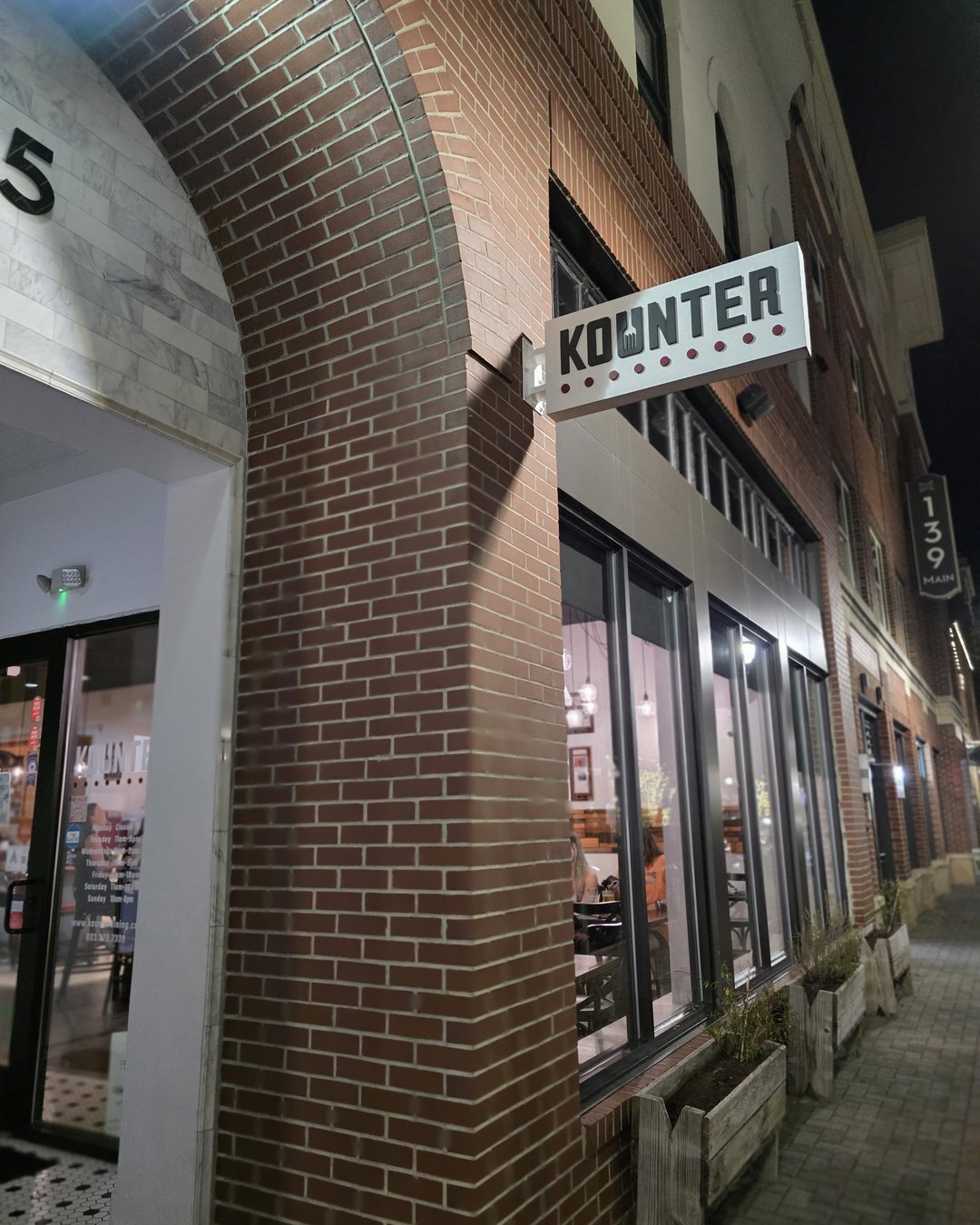 Kounter restaurant sign on brick building in downtown Rock Hill SC at night